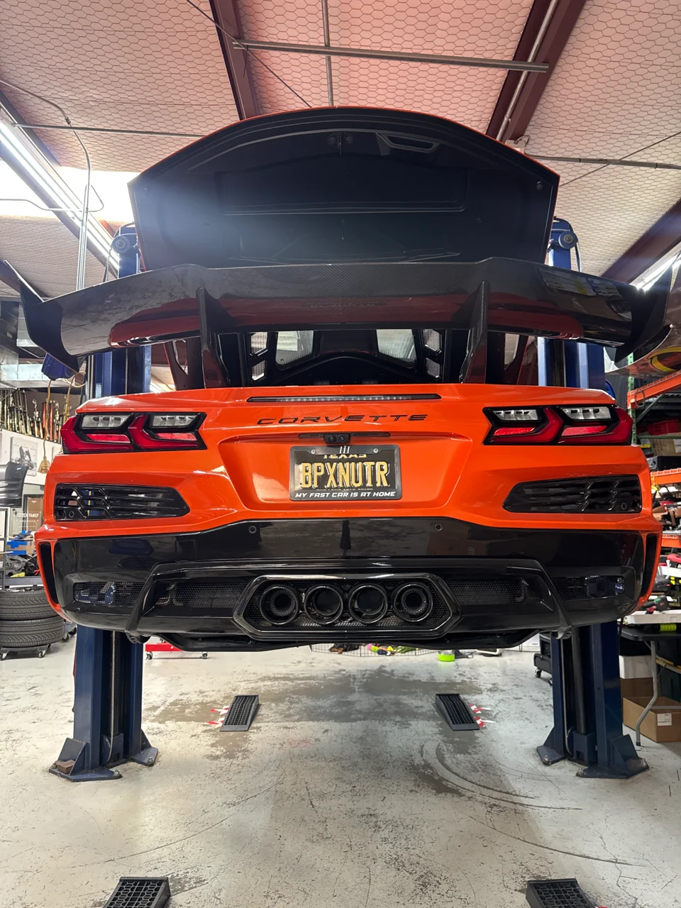Your AFD exhaust and cat-delete system are installed, with quad tips and a carbon fiber wing visible.
