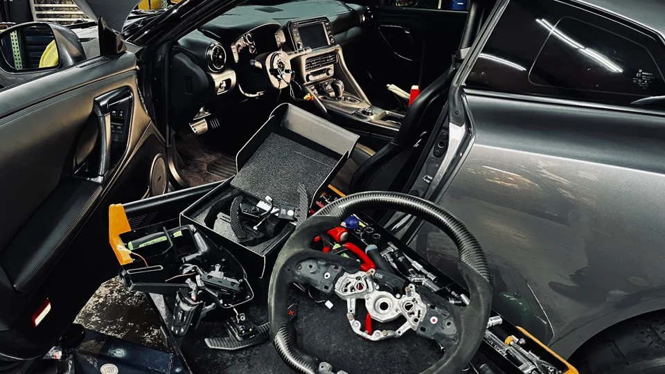 Your steering wheel is off, preparing for the new MAGNETIC CARBON FIBER PADDLE SHIFTERS installation.