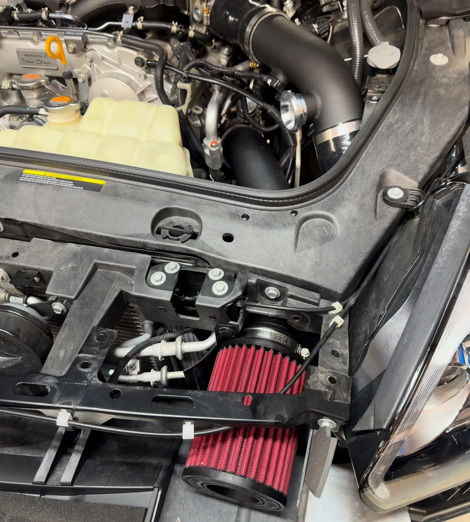 The Boost Logic 3" intake kit with MAF and red air filters is now in place.