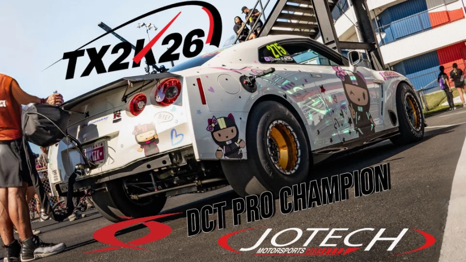 White Nissan GT-R with custom livery and drag tires at TX2K drag racing event, with Jotech Motorsports branding.