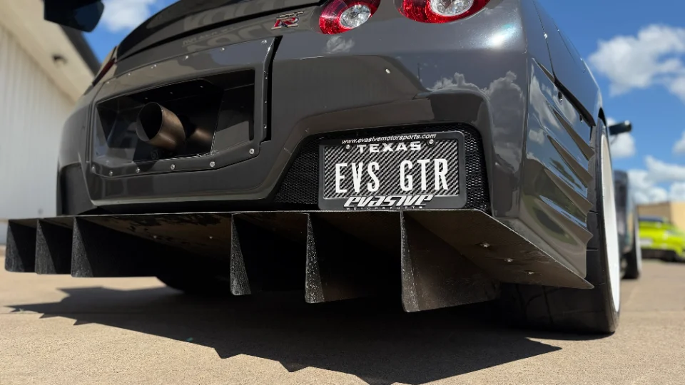 Rear view of a grey Nissan GT-R R35 with a large carbon fiber rear diffuser, widebody kit, and single exit exhaust.