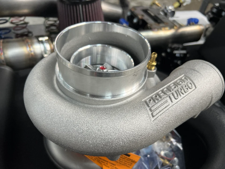 Close-up of a Precision Turbo turbocharger, a key component for high-performance engine builds.
