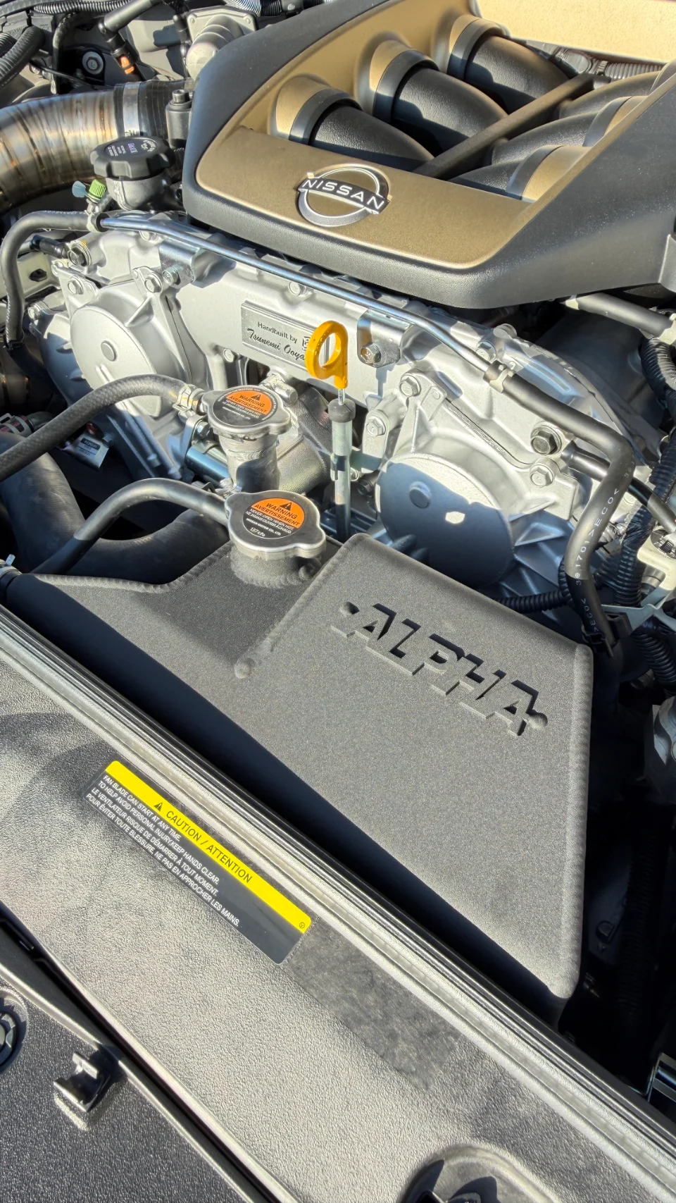 Close-up of a Nissan GT-R VR38DETT engine bay featuring an Alpha Performance intake system.