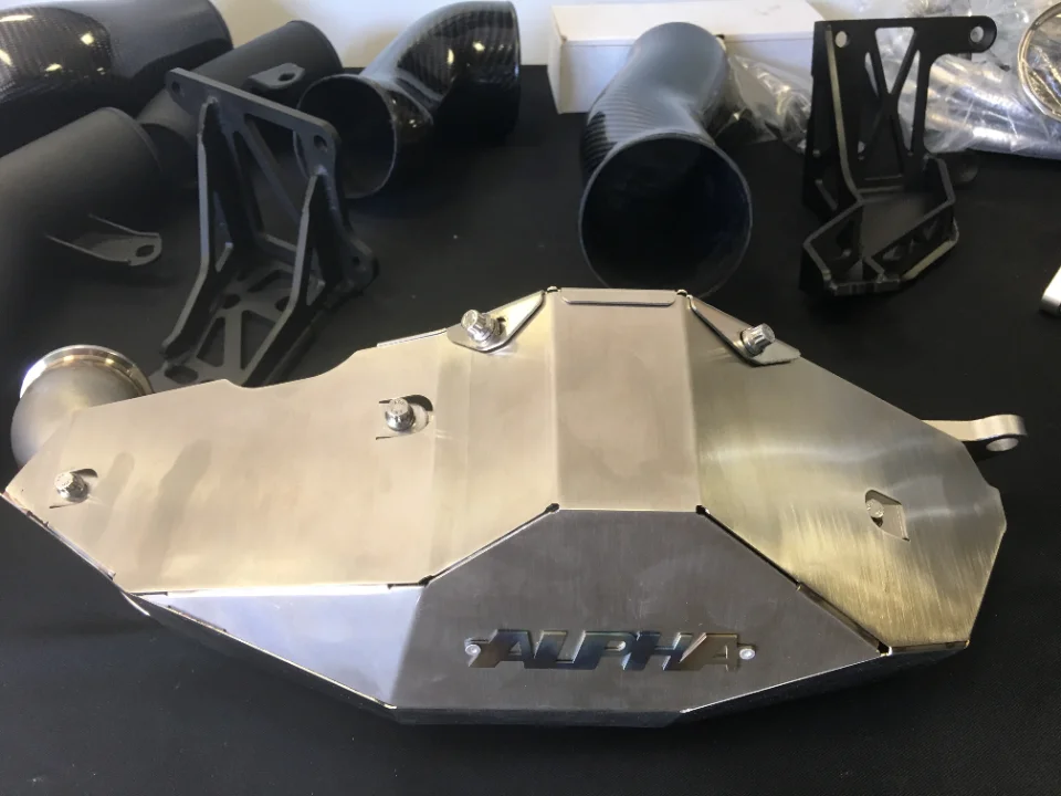 Alpha Performance carbon fiber intake system and airbox components for a high-performance vehicle.