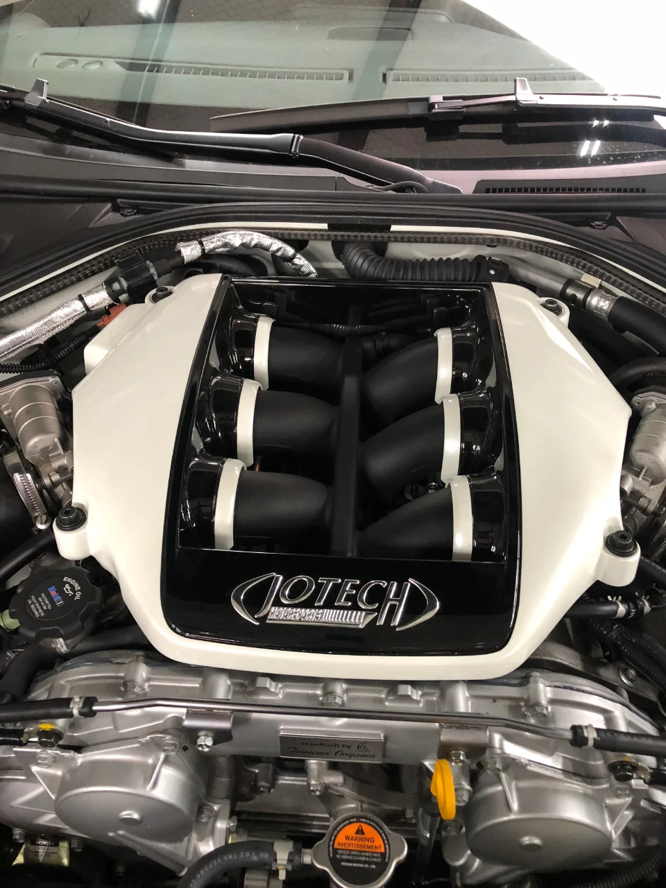 Close-up of a Jotech tuned Nissan GT-R VR38DETT engine bay with custom intake manifold.