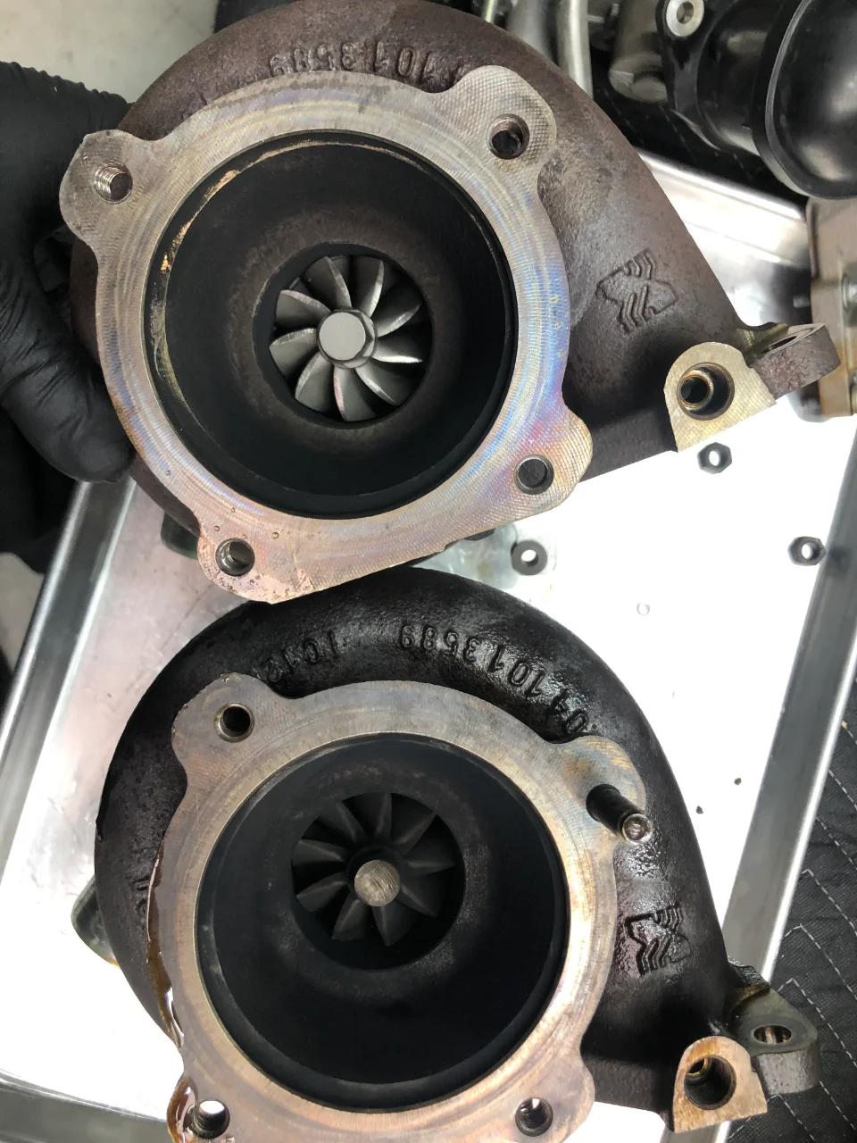 Two turbochargers with visible compressor wheels, likely for an automotive performance upgrade.