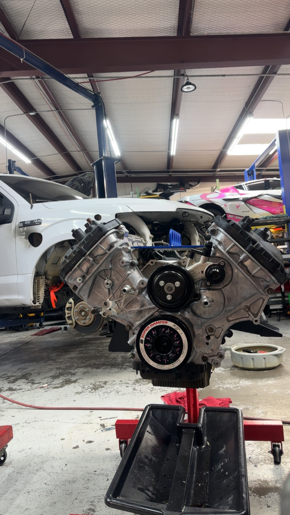 Ford F-150 V8 engine on an engine stand in a Jotech Motorsports shop