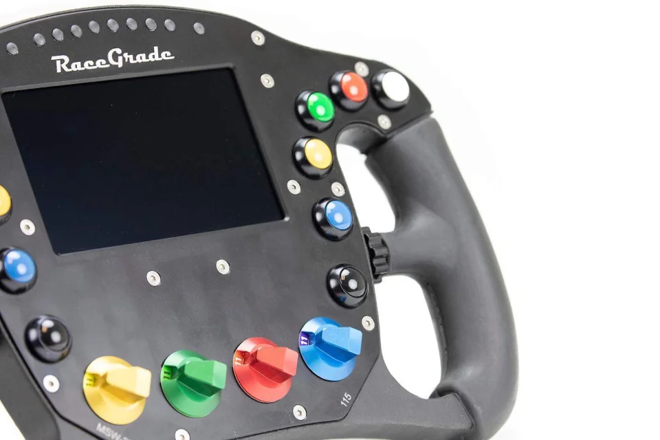 Close-up of a RaceGrade racing steering wheel with a digital display, colorful buttons, and control knobs on a white background.
