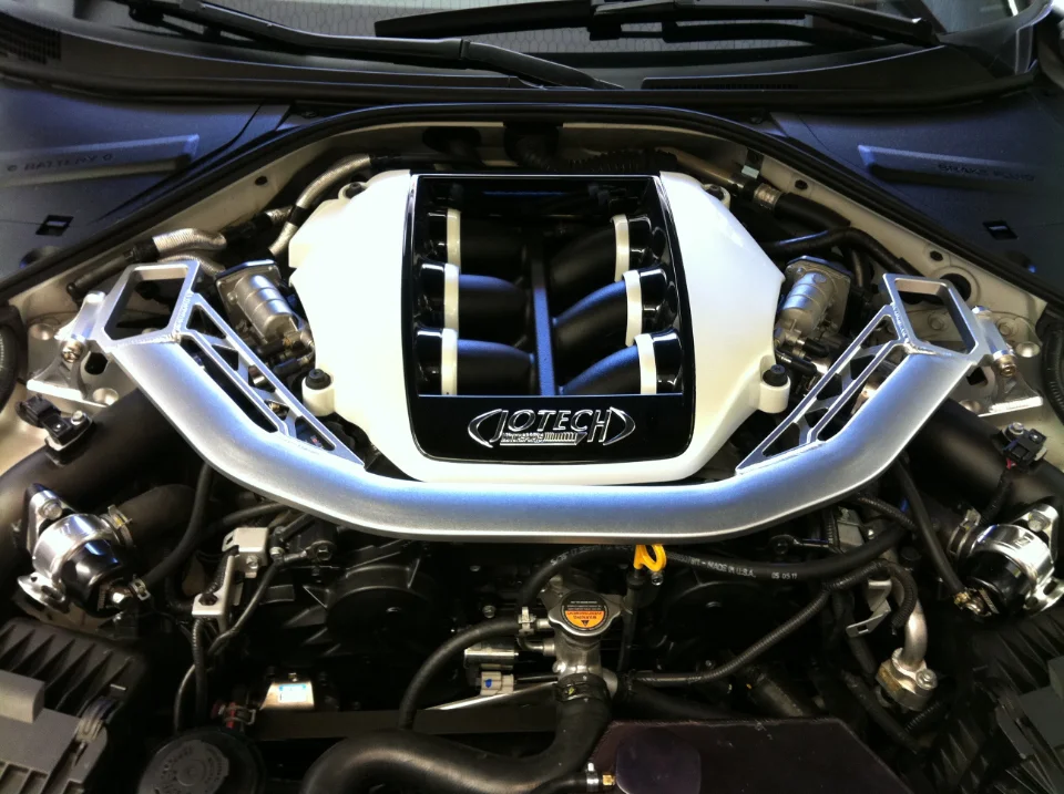 Close-up view of a Jotech tuned engine bay featuring an aftermarket intake manifold and strut bar.