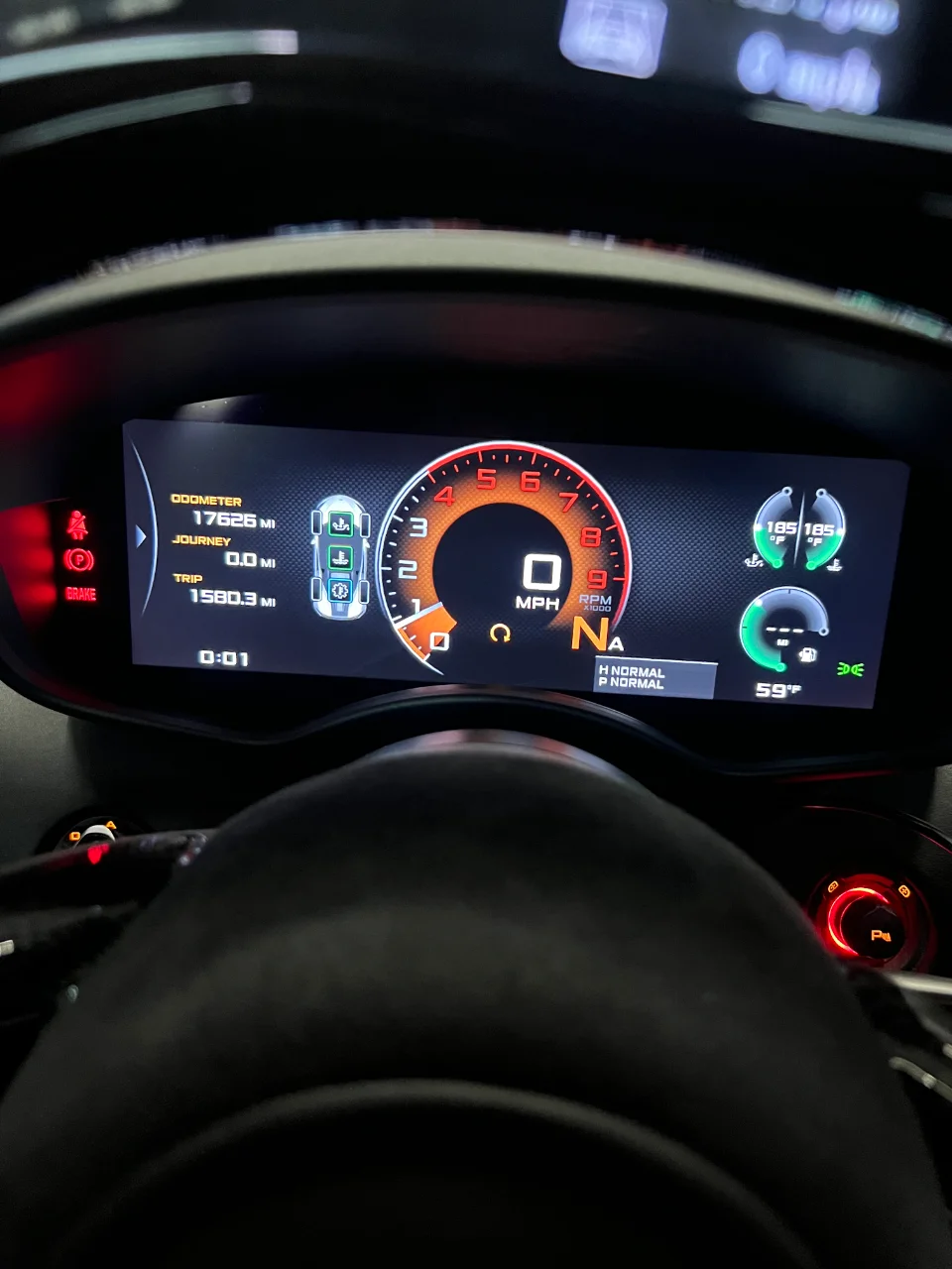 Digital dashboard of a McLaren showing odometer, speed, RPM, and various car status indicators.