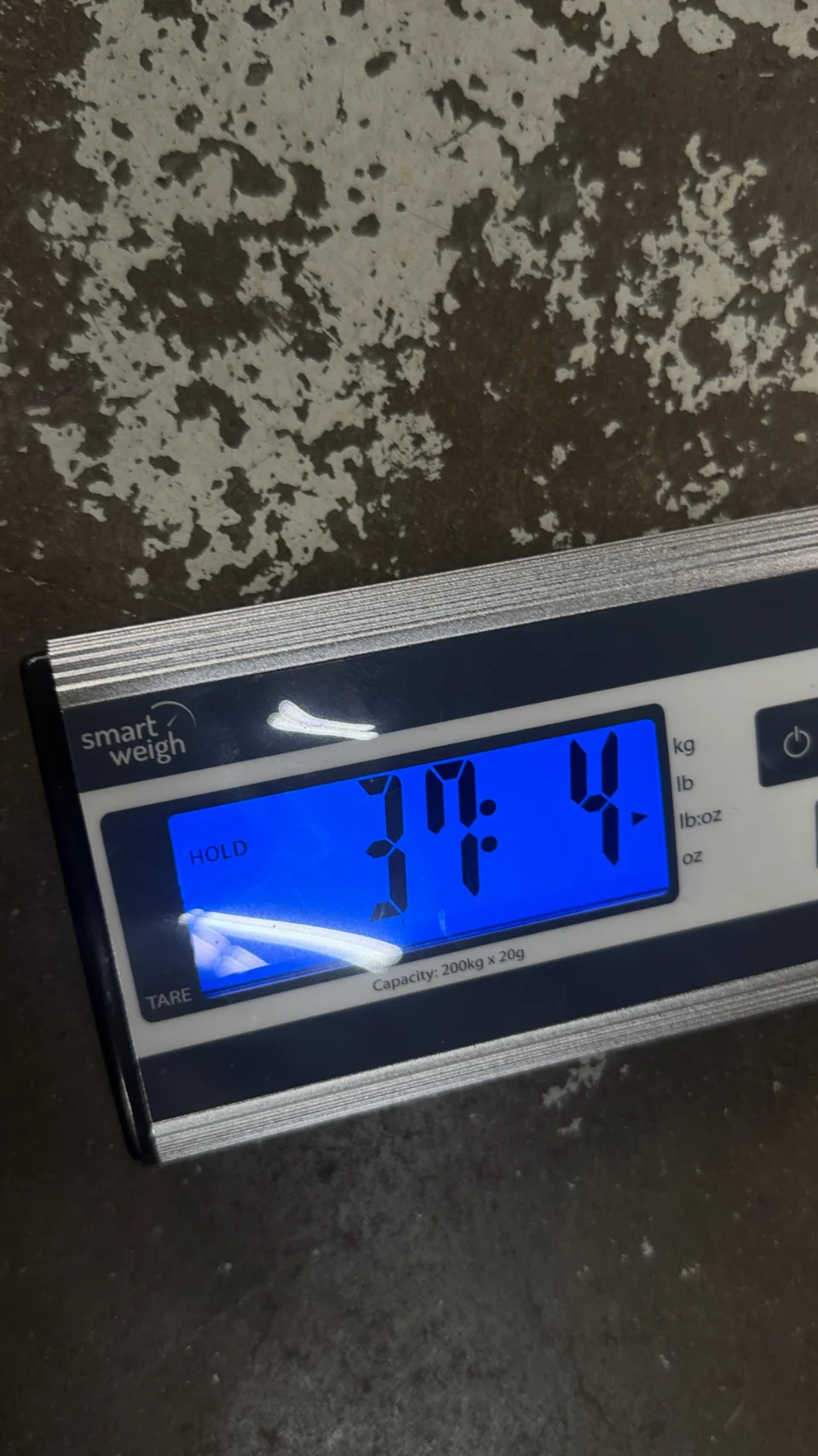 A Smart Weigh digital scale displaying a measurement of 37.4, likely for a car part or component.
