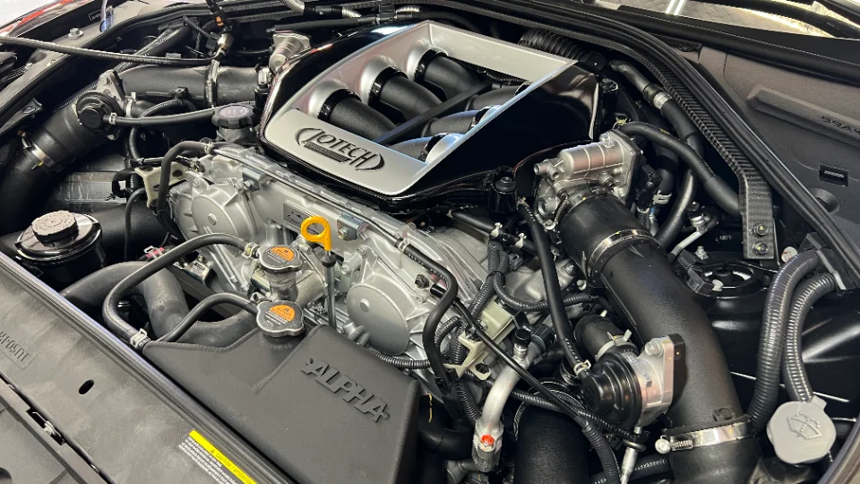 Close-up of a Jotech tuned engine bay with an aftermarket intake manifold and induction system.