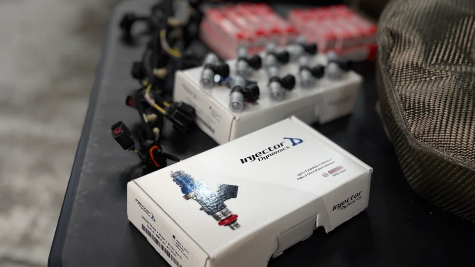 Injector Dynamics fuel injectors in their packaging, ready for installation on a high-performance vehicle.