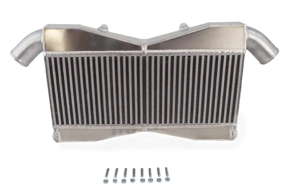 Aluminum performance intercooler with inlet and outlet pipes on a white background, shown with mounting hardware.