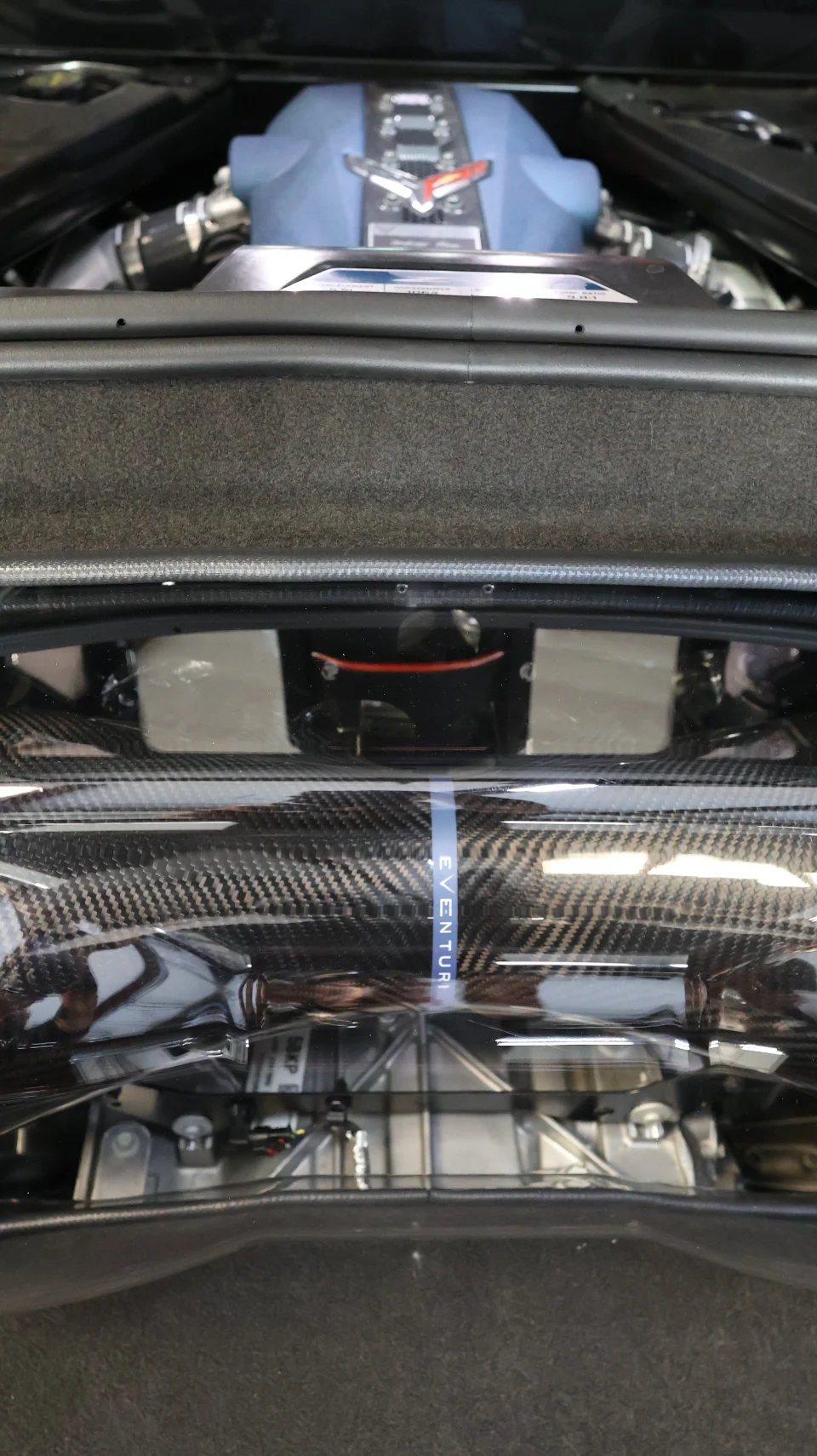 Close-up of a C8 Corvette engine bay featuring an Eventuri carbon fiber intake system.