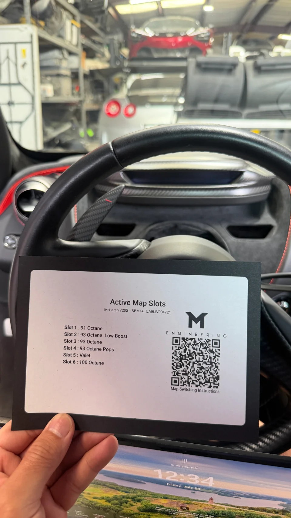 A hand holds an M Engineering card inside a McLaren 720S, displaying active engine tuning map slots for different octane fuels.
